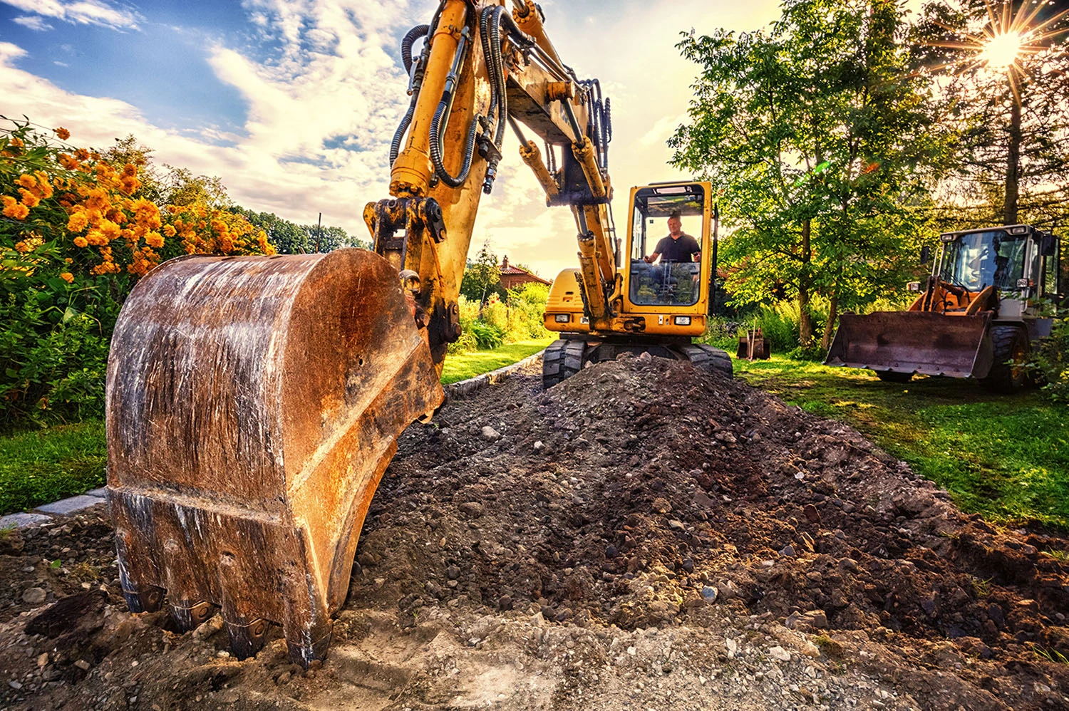Man on excavator, preparing the Underground for Pavement 